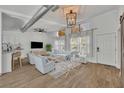 Bright living room features an open floor plan, lots of natural light, and an industrial-style ceiling at 67 Sabal Cay Court, New Smyrna Beach, FL 32169
