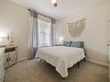 Cozy bedroom with carpeted floor and large window at 7043 Oxbow Rd, Minneola, FL 34715