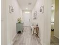 Light and bright entryway with tile flooring and storage bench at 7043 Oxbow Rd, Minneola, FL 34715