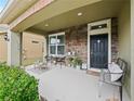 Inviting front porch with stone accents and seating at 7043 Oxbow Rd, Minneola, FL 34715