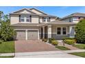 Two-story house with a two-car garage and neatly landscaped front yard at 8060 Bowery Dr, Winter Garden, FL 34787