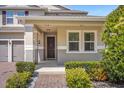 Inviting front entrance with a covered porch and well-maintained landscaping at 8060 Bowery Dr, Winter Garden, FL 34787