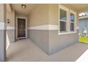 Front porch entryway with dark brown door and sidelights at 8060 Bowery Dr, Winter Garden, FL 34787