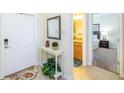 Bright entryway with mirror, console table, and view of bedroom at 8956 California Palm Rd, Kissimmee, FL 34747