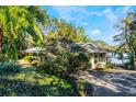 Lakefront property with a charming house nestled among trees at 1115 Lake Nettie Dr Dr, Eustis, FL 32726