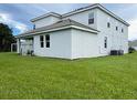 Rear view of two story house with covered patio and large backyard at 1445 Olympic Club Blvd, Champions Gate, FL 33896