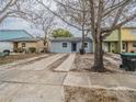 Newly renovated home with a front yard, driveway and large tree at 2419 Rio Pinar Lakes Blvd, Orlando, FL 32822
