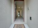 Open door revealing a bright hallway with tile floors at 2649 Howland Blvd, Deltona, FL 32738