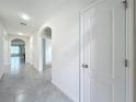 Long hallway with tile floors and doors to other rooms at 2649 Howland Blvd, Deltona, FL 32738
