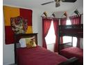 Bedroom featuring twin beds, a bunk bed, themed decor, and a window with red curtains at 2803 Lido Key Ct, Kissimmee, FL 34747