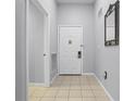 Simple entryway with tiled floors and a white door at 3050 Pirates Retreat Ct # 303, Kissimmee, FL 34747