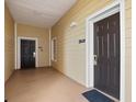 Building hallway with two dark brown doors and light beige walls at 3050 Pirates Retreat Ct # 303, Kissimmee, FL 34747