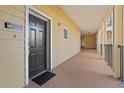 Building hallway with dark brown doors and light beige walls at 3050 Pirates Retreat Ct # 303, Kissimmee, FL 34747