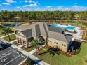 Aerial view of clubhouse, pool, and tennis courts at 3214 Arch Ave, Ormond Beach, FL 32174