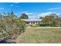 One-story home featuring a lush lawn and colorful landscaping at 4437 Elaine Pl, Orlando, FL 32812