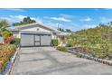 Two-car garage with a large concrete driveway at 4437 Elaine Pl, Orlando, FL 32812
