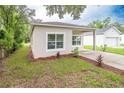 Newly built home with a side yard and a driveway at 4924 College Dr, Orlando, FL 32811