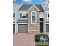 Two-story townhome with stone accents and a two-car garage at 558 S Terrace Spring Dr, Orlando, FL 32828
