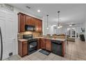 Eat-in kitchen with dark wood cabinets and granite countertops at 558 S Terrace Spring Dr, Orlando, FL 32828