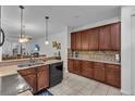 Spacious kitchen with dark wood cabinets and granite countertops at 558 S Terrace Spring Dr, Orlando, FL 32828