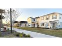 Row of two-story houses with similar design and landscaping at 10876 Waterwood Aly, Orlando, FL 32829
