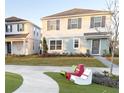 Two-story house with light blue and white siding, landscaping, and a driveway at 10876 Waterwood Aly, Orlando, FL 32829