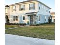 Two-story house with light blue and white siding, landscaping, and a driveway at 10876 Waterwood Aly, Orlando, FL 32829