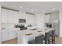 Modern kitchen with white cabinets, stainless steel appliances, and an island at 1365 Hanoverian Dr, Lake Alfred, FL 33850