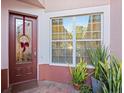 Inviting entryway with decorative door and window at 1402 Lisbon Ct, Davenport, FL 33896