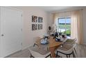 Light and airy dining room featuring a wood table and six chairs at 1672 Hummingbird Rd, Winter Haven, FL 33884