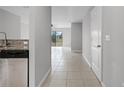 View of home hallway with tile flooring, leading to an open living space at 1952 Piedmont Ct, Mascotte, FL 34753