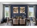 Elegant dining room features a dark wood table and blue accent wall at 2785 Flushing Dr, Apopka, FL 32703