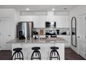 Modern kitchen with white cabinets, granite countertops and stainless steel appliances at 2785 Flushing Dr, Apopka, FL 32703