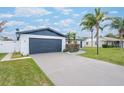 Updated home exterior features modern design and a large driveway at 2932 Carriage Dr, Daytona Beach, FL 32119