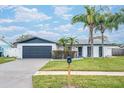 Updated home exterior boasts a modern design, fresh landscaping, and a spacious driveway at 2932 Carriage Dr, Daytona Beach, FL 32119