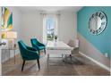 Home office with teal accent wall, desk, and two teal chairs at 316 Corso Loop, Winter Haven, FL 33884