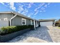 Gray house with a white garage and a paved driveway at 326 Benton St, Orlando, FL 32839