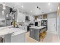 Modern kitchen featuring a marble countertop, stainless steel appliances, and pendant lighting, designed for culinary enthusiasts at 3689 Rolling Hills Ln, Apopka, FL 32712