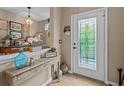 Light and airy entryway with decorative console table and a view into the dining area at 385 Alcove Dr, Groveland, FL 34736