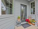 Inviting front entry with decorative planters and a welcome sign at 385 Alcove Dr, Groveland, FL 34736