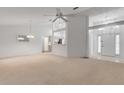 Bright living room with vaulted ceilings and access to a sunroom at 4572 Woodcove Dr, Port Orange, FL 32127