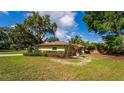 A home's exterior is showcased with mature trees, lawn, and landscaping to enhance curb appeal at 4914 Gran Lac Ave, Belle Isle, FL 32812