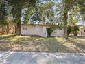 House exterior showcasing a front yard and curb appeal at 5614 Riviera Dr, Orlando, FL 32808