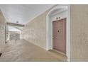 Hallway with mauve door to condo unit 303 at 588 Brantley Terrace Way # 303, Altamonte Springs, FL 32714