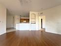 Spacious living room with hardwood floors and kitchen views at 6149 Metrowest Blvd # 106, Orlando, FL 32835