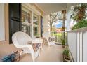 Relaxing front porch with wicker chairs, offering a peaceful view at 8773 Silk Bay Pl, Orlando, FL 32827