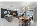 Open concept dining area with modern light fixture and seating for six at 1046 Splash Shot Pl, Davenport, FL 33896