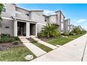 Townhome community featuring modern architecture and lush landscaping at 1046 Splash Shot Pl, Davenport, FL 33896