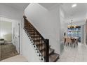 Stylish interior staircase with dark wood railing and carpet runner at 1046 Splash Shot Pl, Davenport, FL 33896