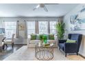 Bright living room features a ceiling fan, modern decor, and lots of natural light at 1057 S Hiawassee Rd # 1911, Orlando, FL 32835